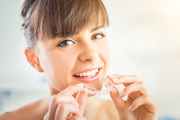 Adult patient using Invisalign in Frisco Texas at Elate Orthodontics